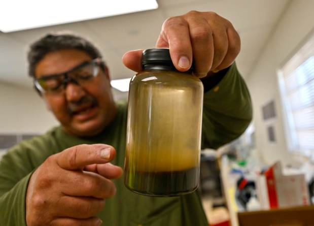Emir Salas, lead chemist at Controlled Thermal Sources, shows off brine with metals extracted at their Hell's Kitchen test facility near the Salton Sea in Niland, CA, on Wednesday, April 19, 2023. (Photo by Jeff Gritchen, Orange County Register/SCNG)